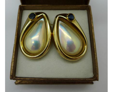 A pair of 9ct gold set Mabe teardrop pearl and 1ct Singapore sapphire earrings, made by Carolyn Codd, Nottingham, total weigh