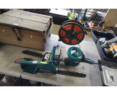 A Black and Decker electric chainsaw together with a Makita UH4500 electric hedge trimmer and an extension reel