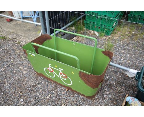 A green painted metal planter/bicycle rack