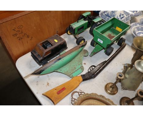 A Tonka Toy tractor and trailer, a tin plate pond yacht, a Tonka Toy van and a D B Marx toy gun