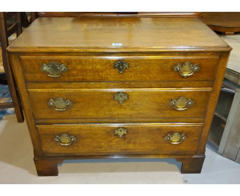 A good quality 20th century oak Georgian style chest of three drawers on bracket feet with canted front corners, of smaller d