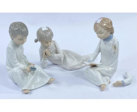 Three Nao figures of children in night attire (boy's arm a.f.) 