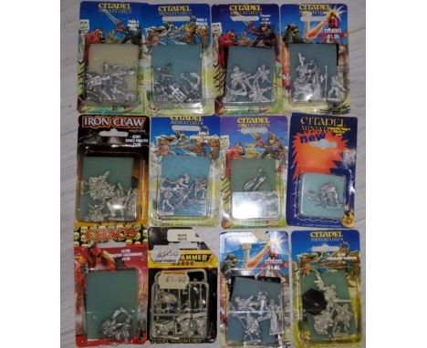 Nine Early Games Workshop Citadel miniatures originally packaged sets including C Chainsaw Warrior, Space Elf and and Astropa