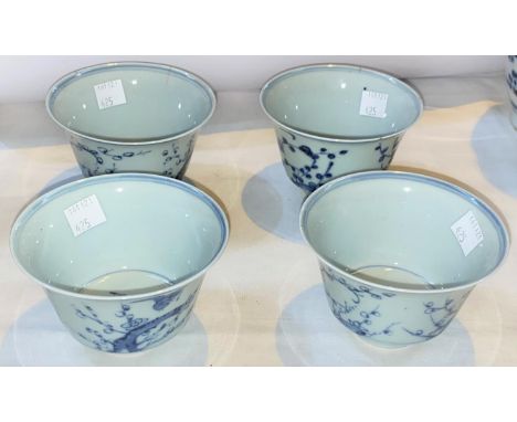 Four Chinese blue and white tea bowls with Prunus blossom decoration with birds, a character mark to the base and similar to 