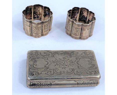 A Georgian chased white metal snuff box unmarked; a hallmarked silver pair of napkin rings, Sheffield 1892 