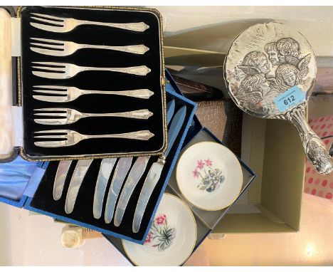 A hallmarked silver back mirror with cherubs; a silver plated fish server and fork, boxed; other boxed cutlery 