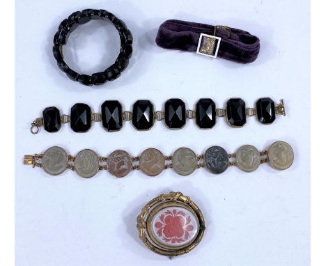 An Italian lava carved cameo bracelet; a jet bracelet; an enamel and seed pearl mounted bracelet etc 