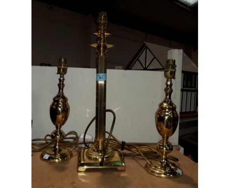 A brass Corinthian column table lamp and two other table lamps 