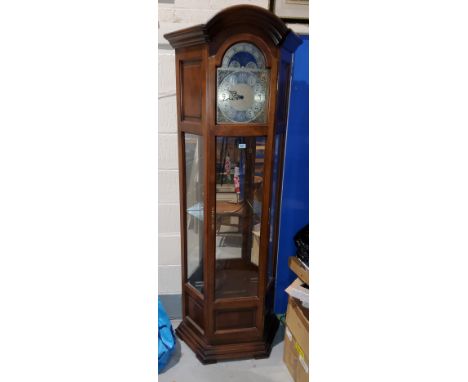 A reproduction long case clock with brass dial, chiming 3 wieght movement and glazed display trunk 