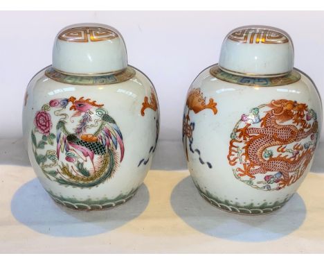 A pair of Chinese ceramic ginger jars with polychrome decoration of dragons and mythical birds, both with six character marks