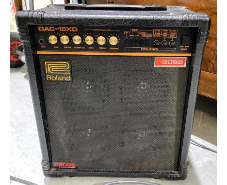 A Roland amplifier with guitar stand and accessories --Seems to work but have not been PAT tested and are sold as non functio