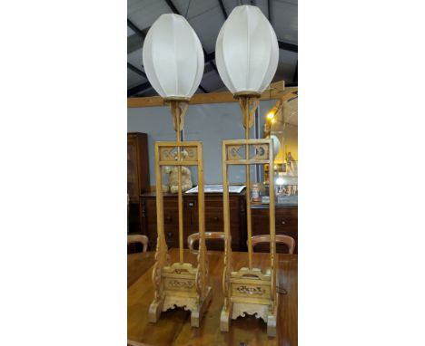 A pair of Chinese carved, pierced, hardwood temple lamp stands, with dragon mounts (converted to electric)Good condition 