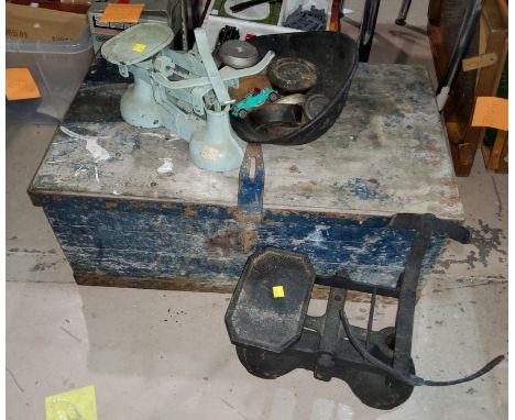 A metal bound tool chest and two vintage weighing scales and a set of weights. 