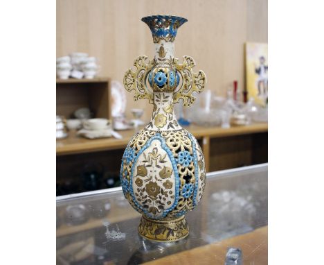 A 19th century pierced porcelain vase by Zsolnay of Hungary. Overall blue &amp; gilt decorated and in the Persian style. 24cm