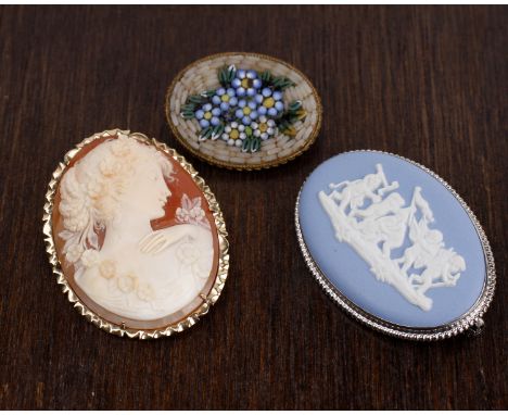 A 14k gold mounted carved shell cameo brooch together with a ceramic Wedgwood style cameo and an Italian micro mosaic brooch.