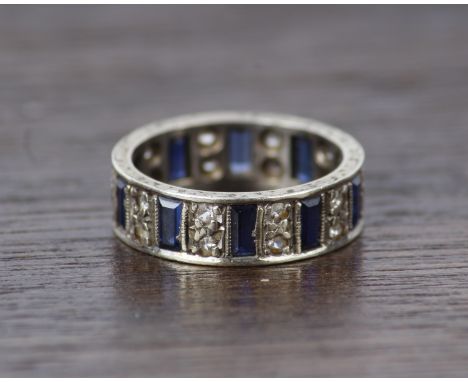 A 9ct white gold diamond and sapphire full eternity ring. 3.2g Size J