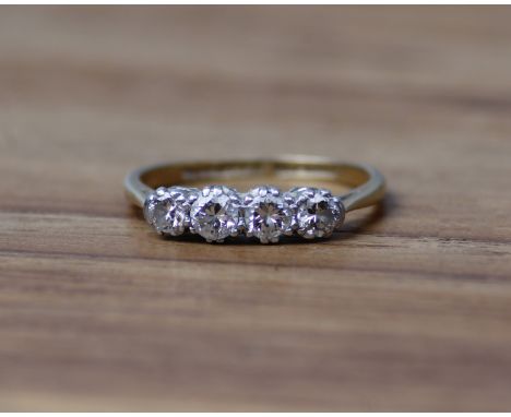 An 18ct gold four stone diamond ring. Size K.