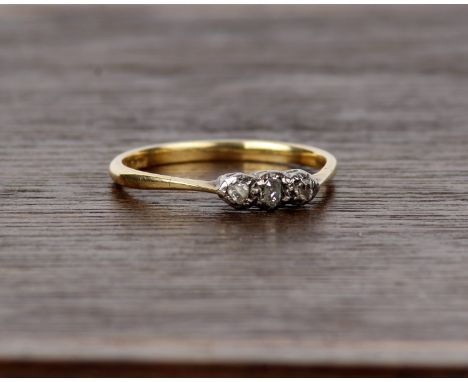 An 18ct gold and platinum three stone diamond ring. Size P 2g. 