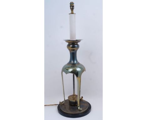 A brass table lamp, 20th century, the faux candlestick electrical fittings with large sconce atop baluster neck, the body wit