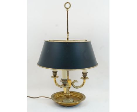 A modern brass bouillotte lamp, with three three eagle-headed branches and adjustable tole peinte shade, 60cm highIt is the b