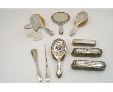 A group of silver mounted vanity items, comprising: a mirror and three matching brushes, with various dates Chester, 1911, Ch