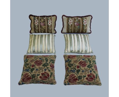 Three pairs of scatter cushions to include: a pair with floral embossed upholstery; a pair with striped silk upholstery; and 