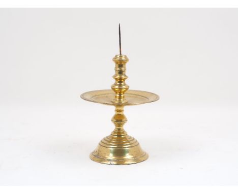 A colonial Dutch brass 'Heemskerk' candlestick, 17th century, with a knopped stem, domed base and wide drip tray, 27cm highPl