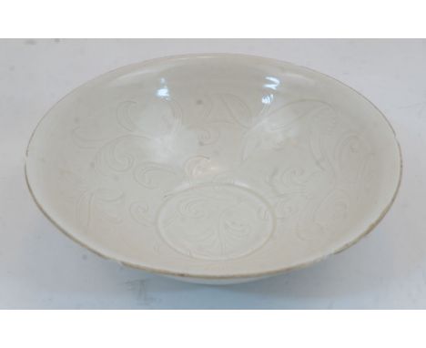 A Chinese Ding style porcelain bowl, 20th century, with moulded floral decoration to the interior and everted rim with regula