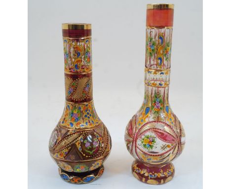 Two Bohemian clear and ruby glass bottle vases, 19th century, each with gilded rims, the bodies enamelled with floral sprays 