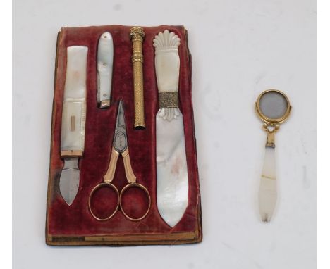 A set of Victorian mother-of-pearl stationary implements, in a velvet lined fitted tray (originally in leather case), compris