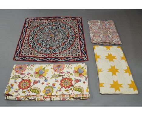A group of quilts and spreads, late 19th / 20th centuries, decorated with geometric and floral motifs, three with a repeating