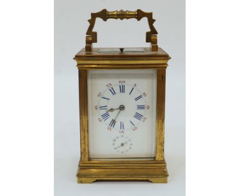 A French gilt-brass repeating carriage clock, late 19th century, the case with swing handle and bevelled glass panels on brac