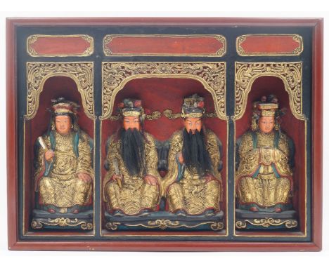 A Chinese red and black painted wood shrine, 20th century, of rectangular form with arcade separated into three arches each w