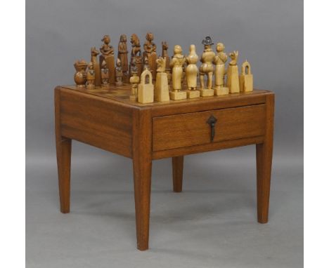 A Peruvian hardwood chess table and set, the removable top with baise lining to reverse, having two drawers, on square taperi