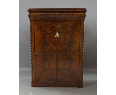 A French flame mahogany secretaire, 19th century, frieze drawer above fall front, enclosing fitted interior, and two cupboard