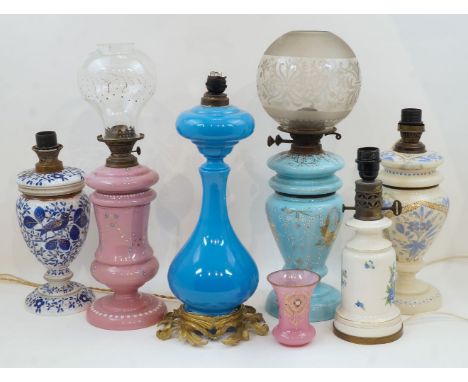 A group of five opaline glass table lamps, late 19th/early 20th century, two with glass shades, converted to electricity, 56c