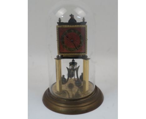 A brass anniversary clock, 20th century, with an adjustable four ball rotary pendulum, the square dial having chapter ring wi