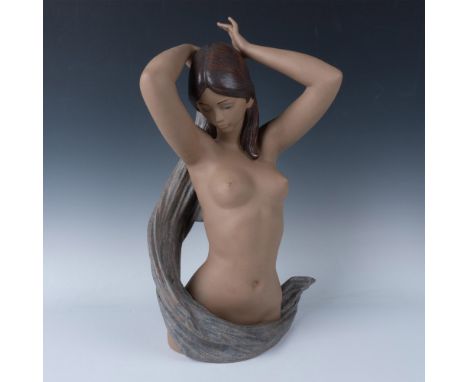 Hand painted figure of a bare beauty holding a multicolored cloth around her body. Lladro backstamp. The dimensions are appro
