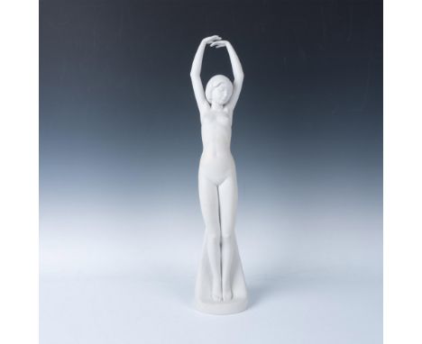 All white porcelain figure of a nude young beauty stretching her arms over her head. Lladro backstamp. Artist and date marked