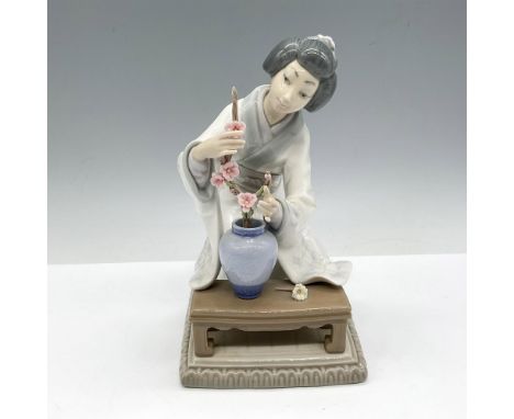 Glossy figure of a Japanese woman arranging flowers. Lladro backstamp. Artist: Vincente MartinezIssued: 1973-1997Dimensions: 