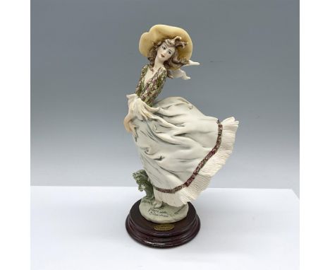 Florence 1995 Figurine Of The Year. Hand painted figure of a beautiful woman in a floral blouse, yellow wide brim hat and a l