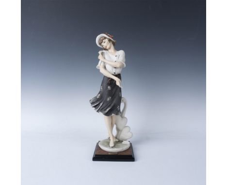 Limited edition. Hand painted figure of a young woman in a white button top and a knee-length black flowing skirt with white 