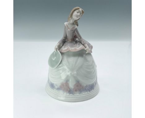 This lovely, glazed bell features a top modeled as a lady holding her hat, delicately hand-painted in soft, muted tones. Llad