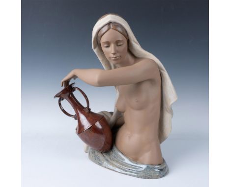 A stunning hand sculpted and hand painted figure of a woman holding a double-handled vase. The beauty is shown wearing a long