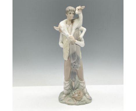 Glossy figure colored in soft cream and bone holding a goat. Lladro backstamp. Artist: Fulgencio GarciaIssued: 1969 - 1985Dim