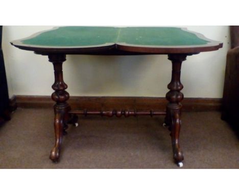 Victorian rosewood card table, shaped fold-over top revealing a baize lined playing surface, bulbous gadrooned supports unite