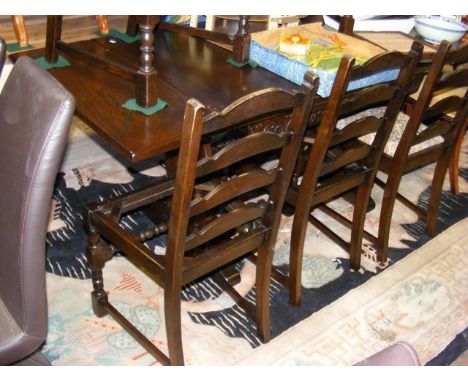 A refectory style oak dining table, together with five ladder back chairs