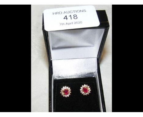 A pair of ruby and diamond stud earrings CONDITION REPORTTotal weight 4.3gThe size of the rubies are 5mm by 3mmLooks like gol