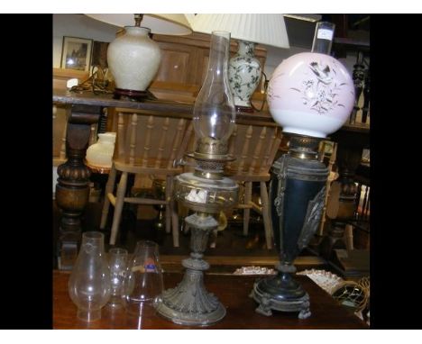 An antique oil lamp with one otherCONDITION REPORTBy our judgement, condition of lot is good- some signs of wear but physical