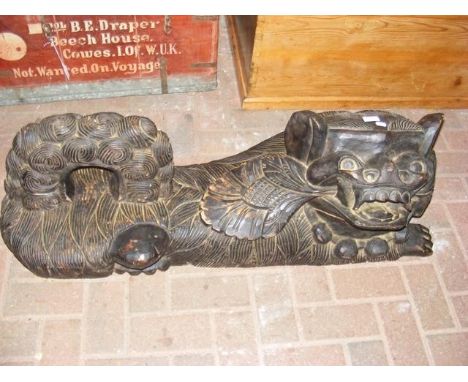 A large carved wooden oriental Dog of Foe - 100cm long CONDITION REPORTBy our judgement, condition of lot is fair- minor dama
